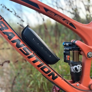 Side view of bluetooth speaker mounted to a bicycle directly to the frame.