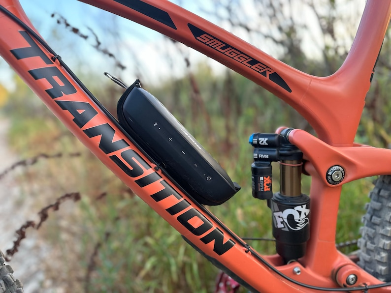 Side view of bluetooth speaker mounted to a bicycle directly to the frame.