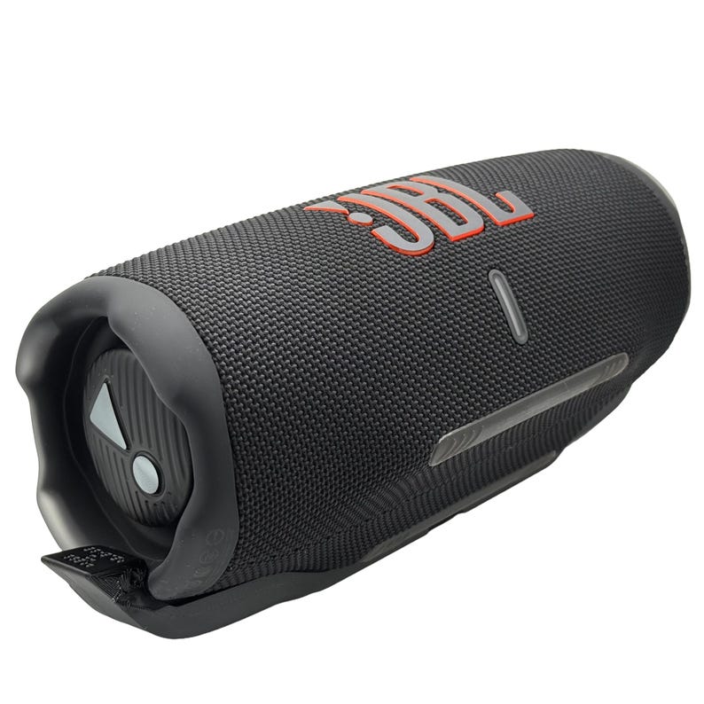 May include: A black portable speaker with the JBL logo in orange. The speaker has a cylindrical shape with a textured surface and a control panel on one end. A silver-colored strip runs along the side.