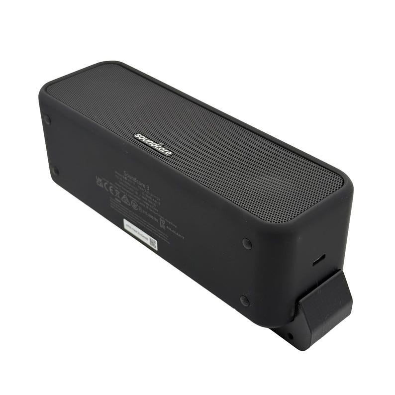 May include: A black Soundcore 2 portable Bluetooth speaker. The rectangular speaker has a mesh top and the Soundcore logo. The speaker has a built-in stand and several ports. The speaker is designed for listening to music.