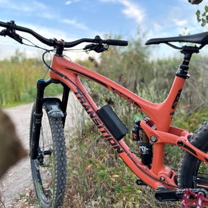 Transition smuggler mountain bike with Bluetooth speaker mounted to it for listening to music