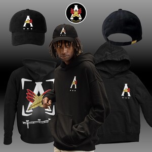 Op de afbeelding: Zwarte hoodie met een witte letter 'A' en rode en gele veren aan de voorkant. Zwarte hoodie met een witte letter 'A' en rode en gele veren aan de achterkant. Zwarte baseballpet met een witte letter 'A' en rode en gele veren. Zwarte baseballpet met een witte letter 'A'.