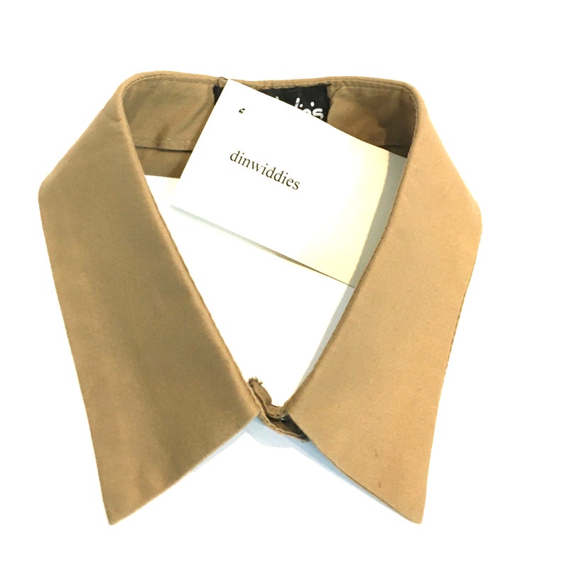 May include: A tan fabric collar with a white tag that says "dinwiddies".
