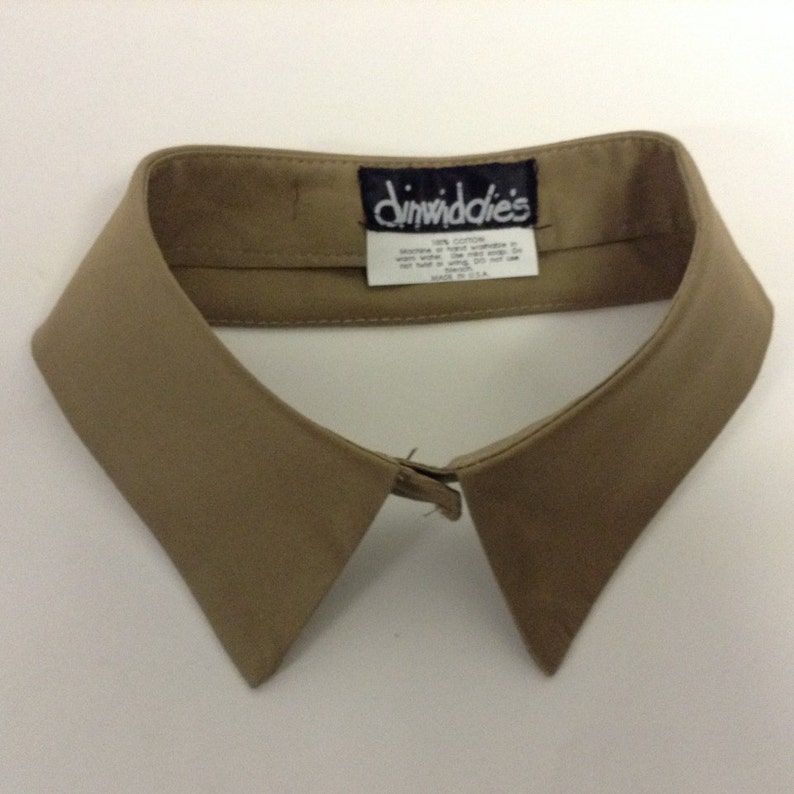 May include: A beige cotton detachable collar with a "Dimwiddies" label. 100% cotton, made in the USA.