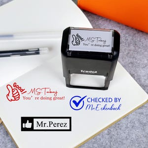 May include: A black stamp with the text "Good! MS. Tabaj, You're doing great!" and a thumbs-up graphic. Additional text includes "Checked by Mr. Eckenbach" and "Mr. Perez."