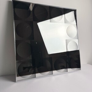 Square optical art wall mirror with graphic monochrome design and chrome frame, collectible 1970s design piece