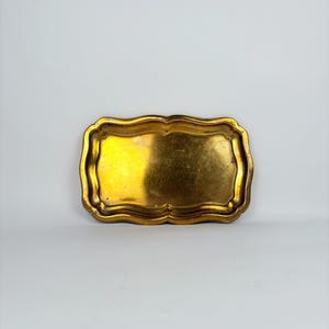 Small vintage brass tray with curved edges, shown on a light background ideal as a jewelry dish, key holder, or vanity tray.