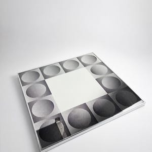 Retro optical illusion mirror with monochrome geometric design, sculptural wall accent from the 1970s