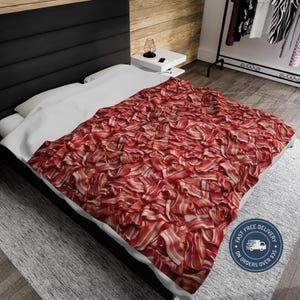 May include: A white bed with a red and white bacon patterned duvet cover. The duvet cover is made of a soft, comfortable material and features a realistic bacon design. The text "Fast Free Delivery on Orders Over $35" is printed on a blue circle sticker on the bottom right corner of the duvet cover.