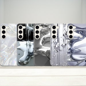 May include: Five different phone cases with a liquid metal design. The cases are all black and white with a silver metallic finish. The cases have a variety of designs, including a marble pattern, a swirling pattern, and a geometric pattern.