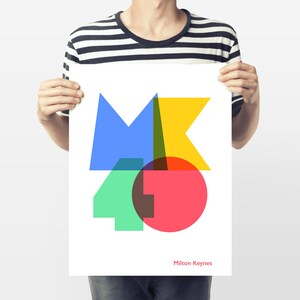 May include: A white poster with a colourful geometric design featuring the letters "MK" and the number "40". The design includes blue, yellow, green, red, and brown shapes. The text "Milton Keynes" is printed in red at the bottom.