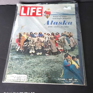 May include: A vintage October 1, 1965 issue of LIFE magazine featuring a cover with the title "Alaska" and the text "19th state-in color." The cover image shows a group of people in traditional clothing.