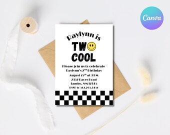 May include: A white invitation card with black text announces Raylynn's 2nd birthday. The text reads "Raylynn is TWO COOL" with a smiley face. The bottom border has a black and white checkered pattern. The invitation is on a brown envelope.