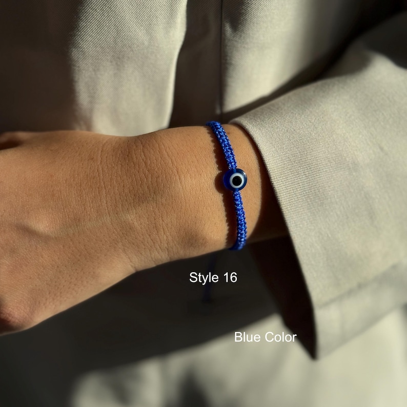 May include: A blue woven bracelet with a central evil eye bead. The bracelet is worn on a wrist, with the text "Style 16" and "Blue Color" visible.