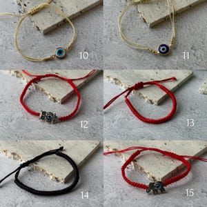 May include: A collection of handmade bracelets featuring various designs. The bracelets include gold and cream-colored cords with blue evil eye charms, red cords with owl and elephant charms, a simple red cord bracelet, and a black cord bracelet.