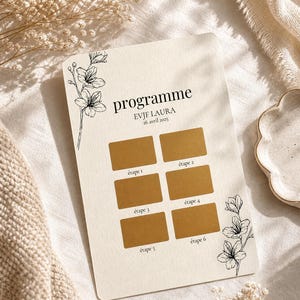 May include: A cream-colored card with the word "programme" and the text "EVJF LAURA 26 avril 2025". It features six gold scratch-off boxes labeled "étape 1" through "étape 6", and is decorated with floral line art.