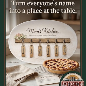 May include: An oval Mom's Kitchen sign with name tags, a pie, and text that reads "Turn everyone's name into a place at the table." The sign has a wooden bar with six name tags: James, Emma, Amy, Connor, Robert, and Jack. A pie sits on a wire rack.
