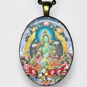 May include: Oval pendant necklace featuring a detailed illustration of a seated deity with a green complexion, surrounded by floral and celestial elements. The pendant is suspended from a dark chain.