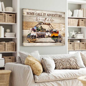 May include: A wooden wall art piece with the text "SOME CALL IT ADVENTURE We call it life." The artwork features a buggy silhouette filled with various photos. The background is a light brown wood grain.