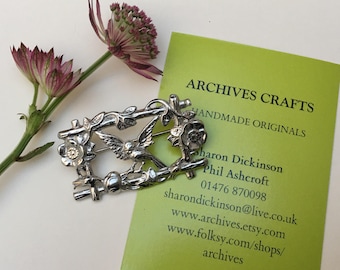 Bird brooch pin.