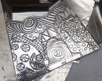 Abstract pewter mirror.