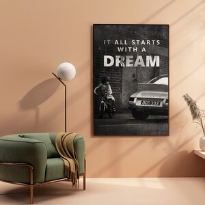 May include: Black and white photo print of a child riding a bicycle in front of a classic car with the text "It all starts with a dream" printed on the wall behind them.