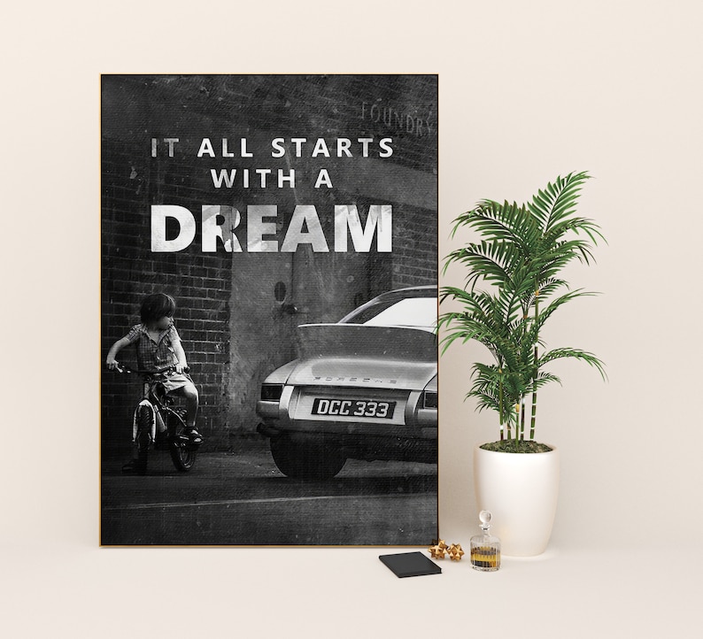 May include: Black and white photograph of a child riding a bicycle in front of a vintage Porsche with the text "It all starts with a dream" on a brick wall.