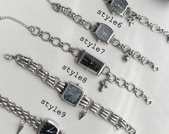 May include: Ten silver chain bracelets with different charms and black square watch faces. The bracelets are labeled "style6", "style7", "style8", "style9", and "style10".