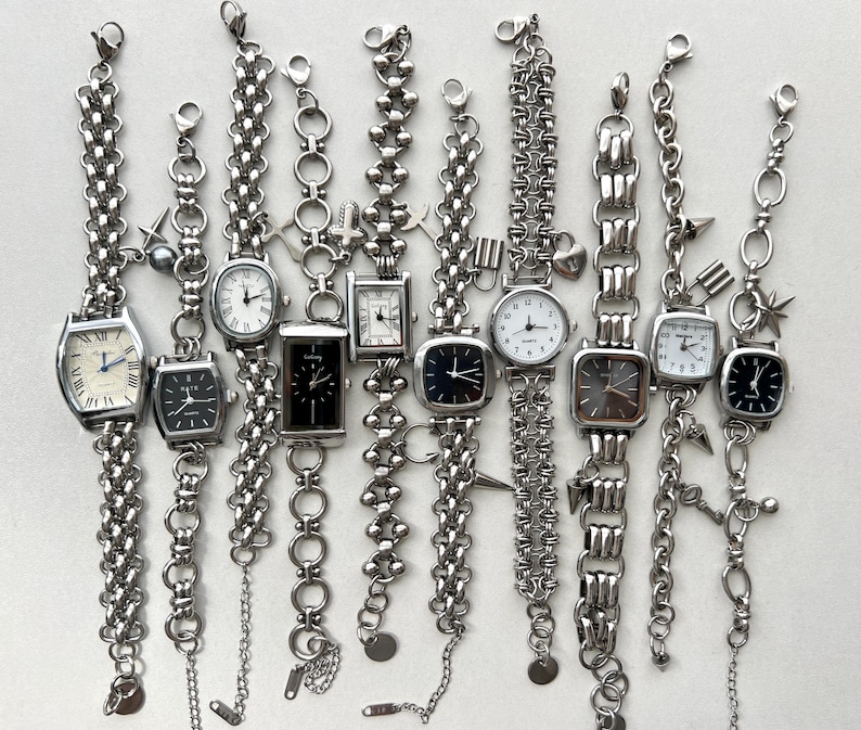 May include: Ten silver-toned wristwatches with different chain link and beaded bracelets. Each watch has a square or rectangular face with a white or black dial.