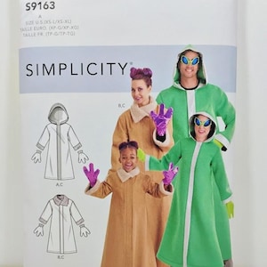May include: A Simplicity S9163 sewing pattern envelope for costumes. The package displays illustrations and photographs of long coats with hoods and collars, including a green alien-themed coat with matching gloves and alien-style sunglasses.