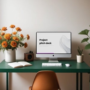 Könnte beinhalten: Ein grüner Schreibtisch mit einem weißen Computermonitor, der eine Präsentation mit dem Titel "Project pitch deck" anzeigt. Auf dem Schreibtisch befinden sich eine Tastatur, eine Maus, ein Notizbuch, ein Lautsprecher aus Holz und eine Vase mit orangefarbenen Blumen.