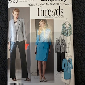 May include: Simplicity sewing pattern featuring a woman in a black and white patterned blazer and black pants. The pattern includes the text "threads MAGAZINE COLLECTION" and the size is U5.
