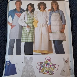 May include: A sewing pattern for five different apron styles. The pattern includes a blue and white striped apron, a green and white gingham apron, a white apron with ruffles, a white apron with a floral print, and a blue apron with an anchor.