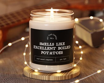 May include: A soy wax candle in a clear glass jar with a black label that reads "Soy Wax Candle No. 1 Smells Like Excellent Boiled Potatoes 100% natural components 9oz / 254g".