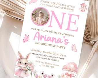 May include: Pink and white birthday invitation with a bunny illustration, flowers, and a mushroom. The invitation says "Is hard to believe but is true our little bunny is turning one. Please join us to celebrate Ariana's 2nd birthday party. Saturday - October 25 - at 2 pm. Men ED's Victory Grill 4010 N Cedar Ave, Fresno, CA 93726123. RSVP by 5 October to Ana at 123-456-7890."
