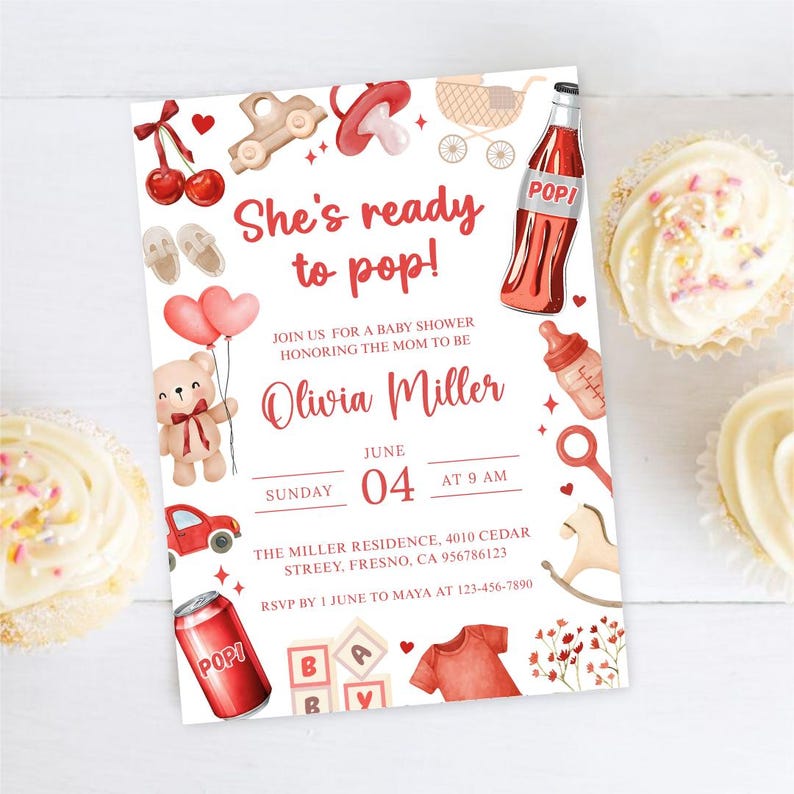 May include: Baby shower invitation with the text "She's ready to pop!" in red script. The invitation features illustrations of baby-related items like a teddy bear, baby bottle, and a red soda bottle. Two cupcakes are on the sides.