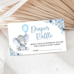 May include: A baby shower diaper raffle card with a watercolor illustration of a gray elephant holding a blue balloon. The card features the text "Diaper Raffle" and instructions for the raffle, with space for a name.