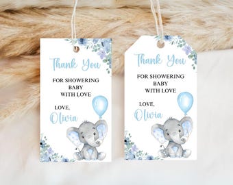 May include: Two white baby shower gift tags with a blue floral design and the text "Thank You" and "For Showering Baby With Love, Love, Olivia." Each tag features a gray elephant holding a blue balloon.