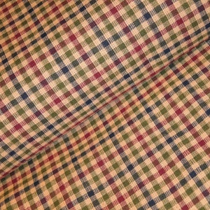 May include: A close-up of a fabric with a checkered pattern in shades of red, green, blue, and beige.