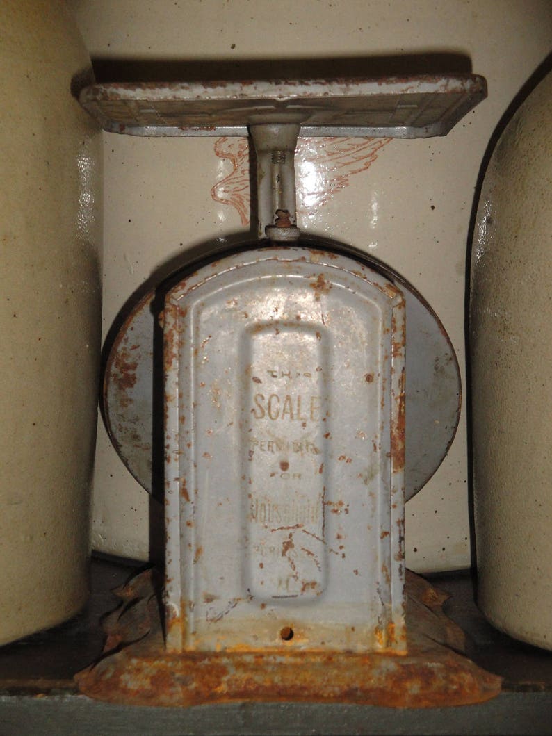 May include: A vintage, rusty, gray metal scale with the words "The Scale" and "Pennsylvania" printed on the front.