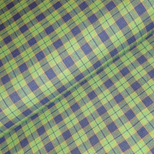 May include: Green and blue plaid fabric with a subtle yellow stripe. The fabric is folded in half, showing the pattern on both sides.