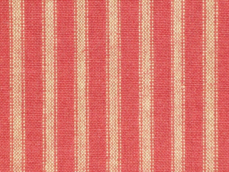 May include: Red and white striped fabric with a woven texture.