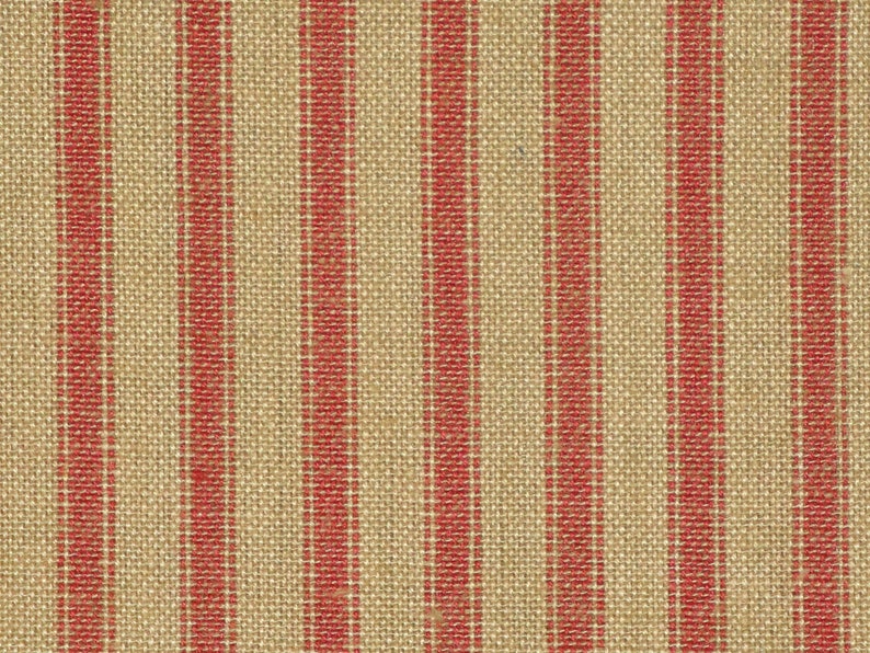 May include: Red and beige striped fabric with a woven texture.
