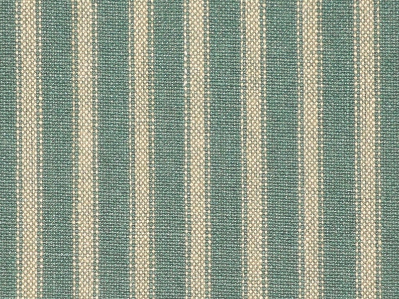 May include: A close-up of a fabric with alternating stripes of teal blue and cream.