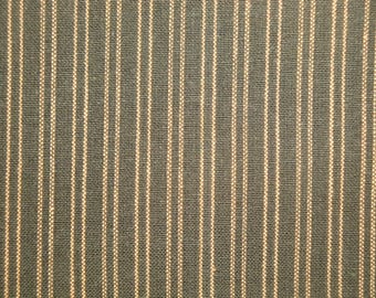 May include: Close-up of a fabric with vertical stripes. The stripes are a light brown color on a dark gray background.