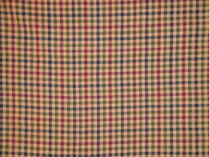 May include: A close-up of a fabric with a checkered pattern in shades of beige, green, red, and blue.