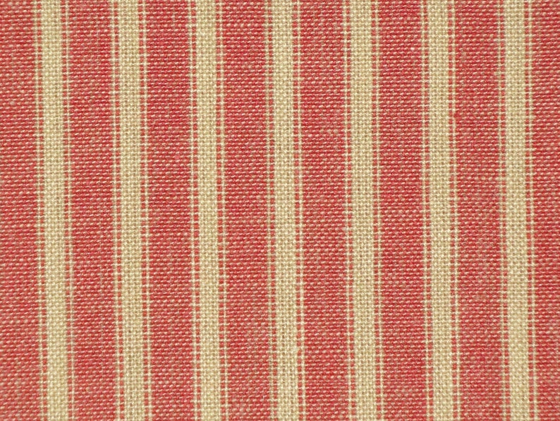 May include: Red and white striped fabric with a woven texture.