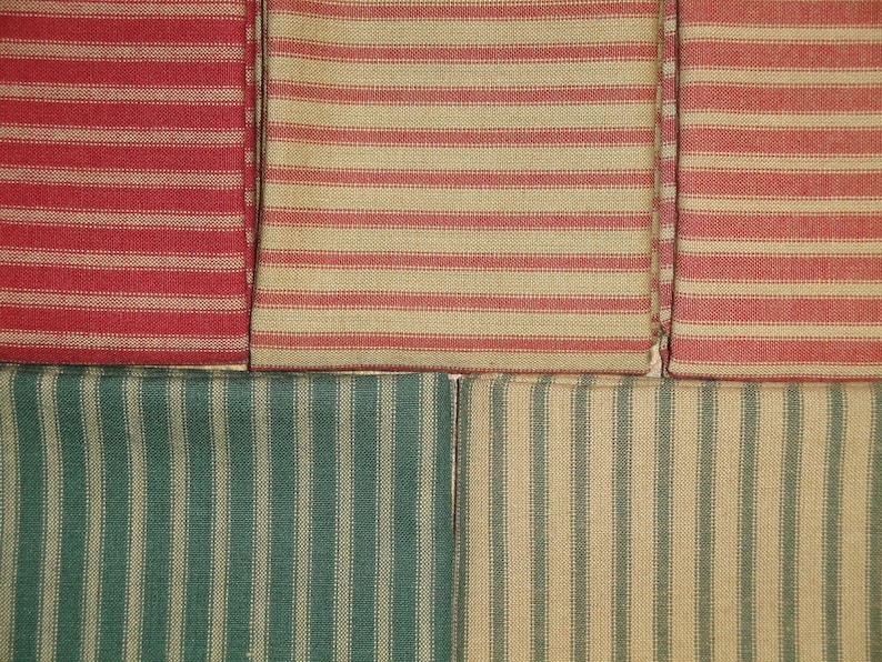 May include: Four fabric swatches with different patterns. The top two swatches are red and tan striped fabric. The bottom two swatches are green and tan striped fabric.