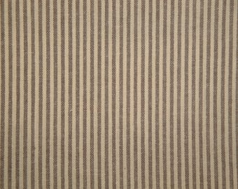 May include: Close-up of a fabric with a repeating pattern of vertical stripes. The stripes alternate between a light beige and a muted brown color. The fabric has a textured appearance, suggesting a woven material.