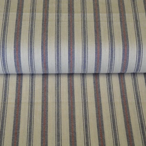 May include: A roll of cream-coloured fabric featuring vertical stripes in navy blue and red. The stripes are evenly spaced, creating a classic, textured appearance. This textile is suitable for various home decor projects. The fabric is rolled, showing the pattern.
